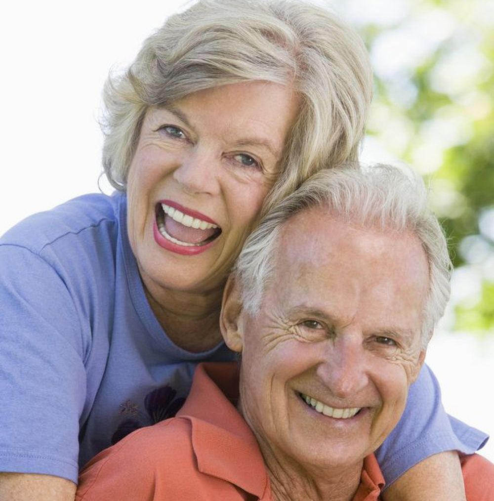 An older couple is happy after getting new dentures at a great price