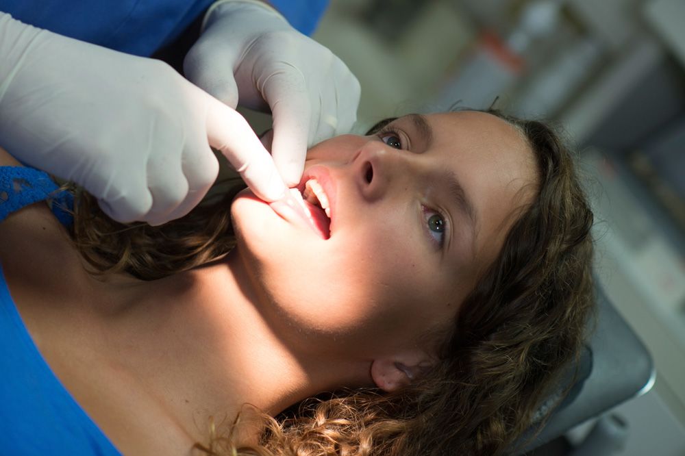 Female patient undergoing oral cancer screening